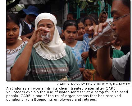An Indonesian woman drinks clean, treated water